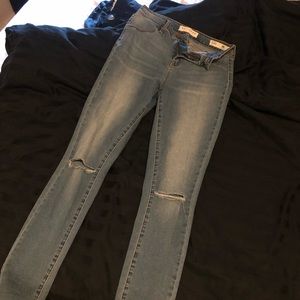 Ripped knee blue jeans